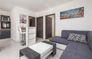 a living room with a couch and a table at Gorgeous Home In Rukavac With Kitchen in Rukavac