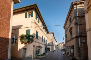 an alley in an old town with people walking down it at La Maison Blanche - Fano Historical Center in Fano