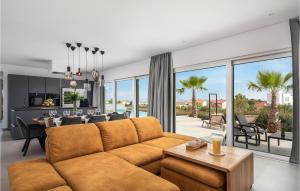 a living room with a couch and a dining room at Awesome Home In Vodice in Vodice