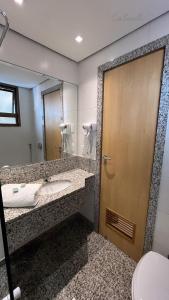 a bathroom with a sink and a mirror at Studio Mauá 705 in Rio de Janeiro +5 photos
