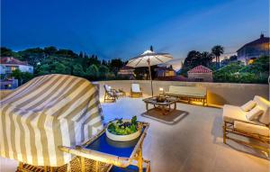 a patio with chairs and a table and an umbrella at Villa Mediteran in Dubrovnik