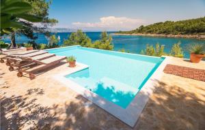 a swimming pool with a view of the water at Villa Aqua in Vrbanj