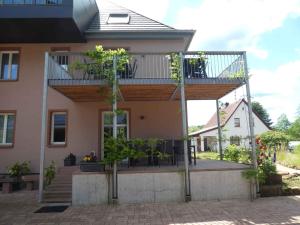 a house with a balcony with plants on it at Apartments in Fischbach bei Dahn - Pfälzerwald 42914 in Fischbach bei Dahn