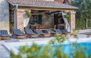 a patio with chairs and a swimming pool at Villa Sisman in Donji Zemunik