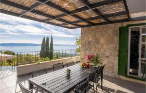 a patio with a wooden table and chairs on a balcony at Villa 2M in Makarska