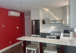 a kitchen with white cabinets and a counter with stools at 925 Rentals in Hamilton