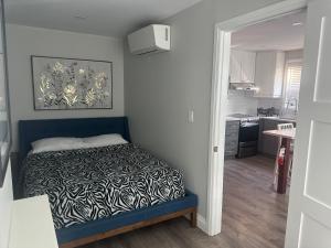 a small bedroom with a bed and a kitchen at 925 Rentals in Hamilton