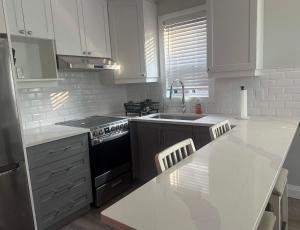 a kitchen with white cabinets and a white counter top at 925 Rentals in Hamilton +2 photos