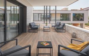 a balcony with chairs and tables and windows at Villa Golden Shine in Poreč