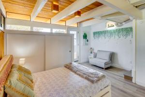 a bedroom with a large bed and a chair at Less Than 1 Mi to Beach and Pepperdine Airy Malibu Studio in Malibu