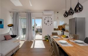 a kitchen and living room with a table and a couch at Villa Valencan 3 in Mednjan