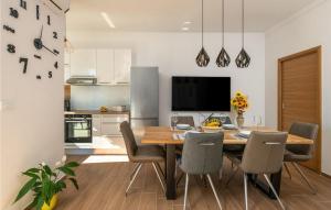 a kitchen and dining room with a wooden table and chairs at Villa Valencan 3 in Mednjan