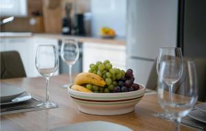 a bowl of fruit on a table with two wine glasses at Villa Valencan 3 in Mednjan +18 photos