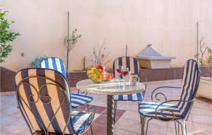 a table and chairs with a bowl of fruit on a patio at Gorgeous Apartment In Baska Voda in Baška Voda