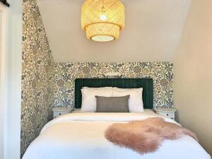 a bedroom with a bed with a furry rug on it at Top Floor Mountain View Escape in Canmore