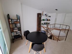 a dining room with a table and two chairs at Cobertura com linda vista da praia do Pêpe in Búzios