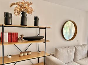 a living room with a couch and a mirror at Sun and Golf Holidays at Mar Menor Golf Resort in Torre-Pacheco