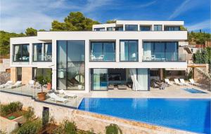 a large white house with a swimming pool at Villa Afrodita in Hvar