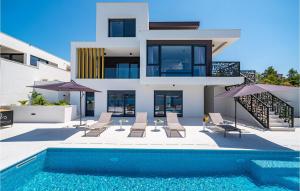 a house with a swimming pool next to a building at Villa Bonella in Novigrad Dalmatia