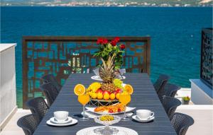 a table with a bowl of fruit on top of the ocean at Villa Bonella in Novigrad Dalmatia