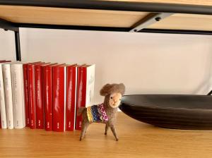 a small toy goat standing in front of books at Sun and Golf Holidays at Mar Menor Golf Resort in Torre-Pacheco