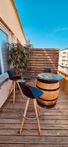 a table and two chairs on a wooden deck at Votre COCON Niçois in Nice