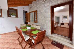 jadalnia z drewnianym stołem i krzesłami w obiekcie Apartments in Porec - Istrien 40311 w Poreču