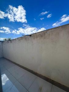 a concrete wall with the sky in the background at Residencial Algarve in Patos de Minas