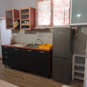 a kitchen with a sink and a refrigerator at B&B Al Melograno in Sant'Isidoro
