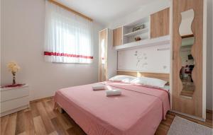 ポヴリャナにある2 Bedroom Cozy Apartment In Povljanaのベッドルーム1室(ピンクベッド1台付)