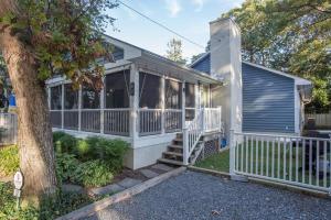 Casa blanca con porche y árbol en Henlopen avenue 62, en Rehoboth Beach