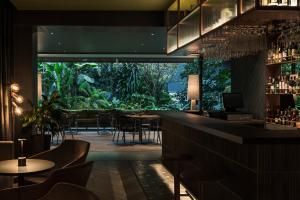 a restaurant with a bar with tables and chairs at Hotel Poblado Plaza in Medellín