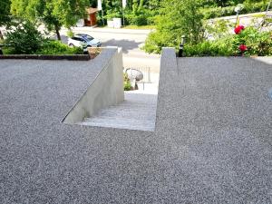 a pair of concrete stairs in a park with trees at White Sand Haven Guest House in Ebhausen