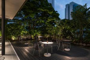 a patio with tables and chairs and a building at Hotel Poblado Plaza in Medellín