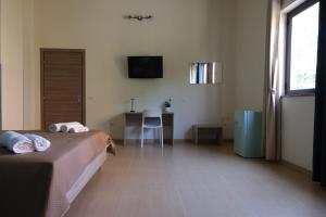 a bedroom with two beds and a desk and a television at B&B Etesia in Vibo Valentia +45 photos