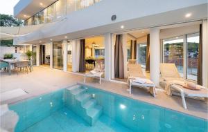 a house with a swimming pool and a patio at Villa Aestas in Vrboska