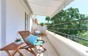 a balcony with two chairs and a table at Villa Valentino in Kornić