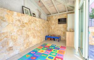 a room with a stone wall and a colorful rug at Villa Valentino in Kornić +39 photos