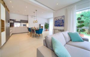 a living room and kitchen with a couch and a table at Villa Valentino in Kornić