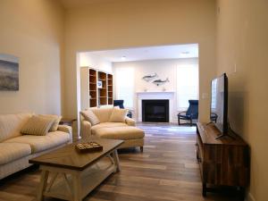 a living room with two couches and a tv at Venice court 21675 in Dewey Beach