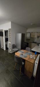a kitchen with a table and chairs and a refrigerator at Paula in Curtea de Argeş