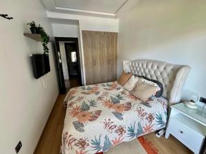 a bedroom with a bed with a floral bedspread at Appartement à louer in Nouaceur +27 photos
