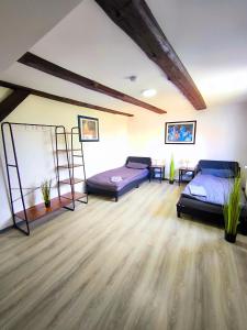 a room with two beds and a wooden floor at Schwert City Loft S64 in Verden +1 photo