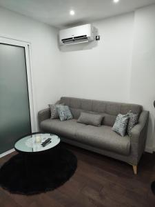 a living room with a couch and a table at Apartman Ani in Vinkovci