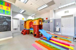 a childs play room with a slide and a playground at Brickell Condo w City View & Pool Access in Miami +18 photos