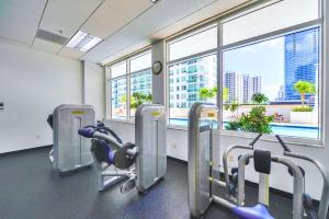 a gym with a view of a city at Brickell Condo w City View & Pool Access in Miami