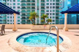 a hot tub on the roof of a building at Brickell Condo w City View & Pool Access in Miami
