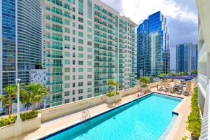 a pool on the roof of a building with tall buildings at Brickell Condo w City View & Pool Access in Miami