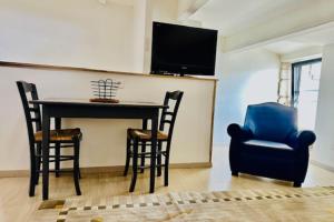 a dining room with a table and two chairs at Studio for two of 25 m2 in Saint-Xandre in Saint-Xandre