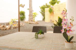 a table with a table cloth on a table with flowers at Oasis Dunas Corralejo in Corralejo